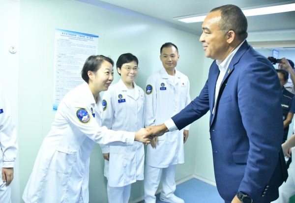 Minister of Health and Wellness, Dr. the Hon. Christopher Tufton (right), extends greetings to team members aboard the People’s Republic of China’s advanced navy hospital ship, the ‘Silk Road Ark’, which docked at Montego Bay Freeport in St. James on Thursday (December 4). 
