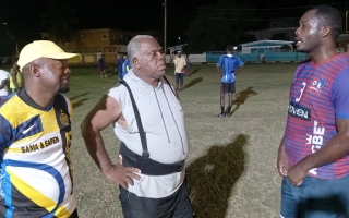 Coaches Jermaine Douglas (left) and Bill Martin (centre) locked in a conversation with Andre Dyce during training at the Old Harbour Glades Community Playfield. (OH News Photo)