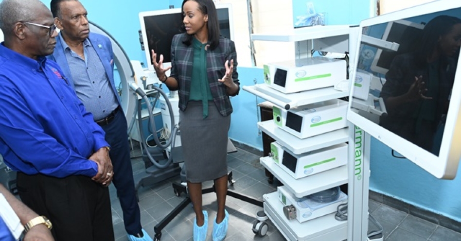 Dr. Sara Marshall Miles (right), Consultant Paediatric Surgeon at BHC, explained to Mr. Wentworth Charles (left), Board Chairman, SERHA and Mr. Billy Heaven (second left), Chief Executive Officer, Chase Fund, about the functions of the laparoscopy machine that was recently donated to the Bustamante Hospital for Children.