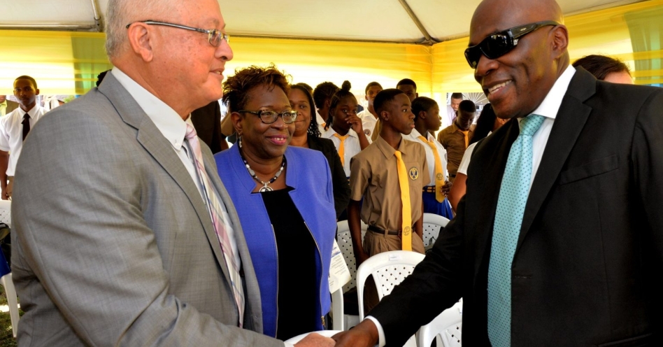 Minister of Justice, Hon. Delroy Chuck (left), greets Chief Justice, Hon. Bryan Sykes (right), at a National Public Education Symposium in Spanish Town, St. Catherine, today (November 20). At centre is Director of Public Prosecutions (DPP), Paula Llewellyn. (JIS Photo)