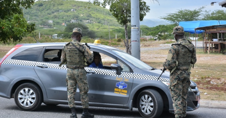 A taxi operator is stopped at a check point at the border of St Catherine and Clarendon on April 17, 2020. (Photo: Peter Simmonds/Mystic5 Multimedia Services)