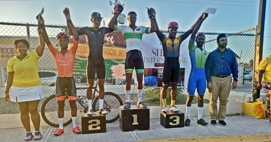 Jaequan Dixon stands atop the podium after winning the feature race ahead of Peter Thompson and Barenton Bailey. Damaine Douglas (2nd left) and Jerome Forrest (2nd right) were fourth and fifth respectively. Sharing in the presentation is Imam, Ahmadiyya Muslim Jamaica Tariq Azeem (right) and Velana Creary, president, Elevation Cycling Club.