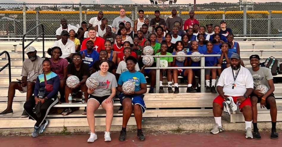 Members of Sports Reach and Fellowship of Christian Athletes share a photo-op with student-athletes at the National Stadium Courts in Kingston.