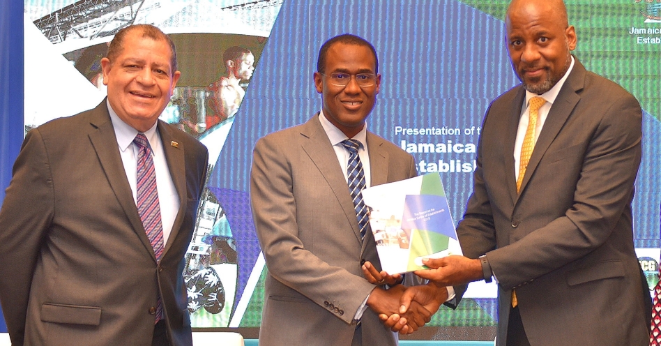Minister of Finance and the Public Service, Dr. the Hon. Nigel Clarke (centre), is presented with a copy of the Planning Institute of Jamaica (PIOJ) 2018 Jamaica Survey of Establishments (JSE) Report by PIOJ Director General, Dr. Wayne Henry, during the document’s launch at the AC Marriott Hotel in Kingston on Wednesday (September 25). At left is Minister of Industry, Commerce, Agriculture and Fisheries, Hon. Audley Shaw. (JIS Photo)