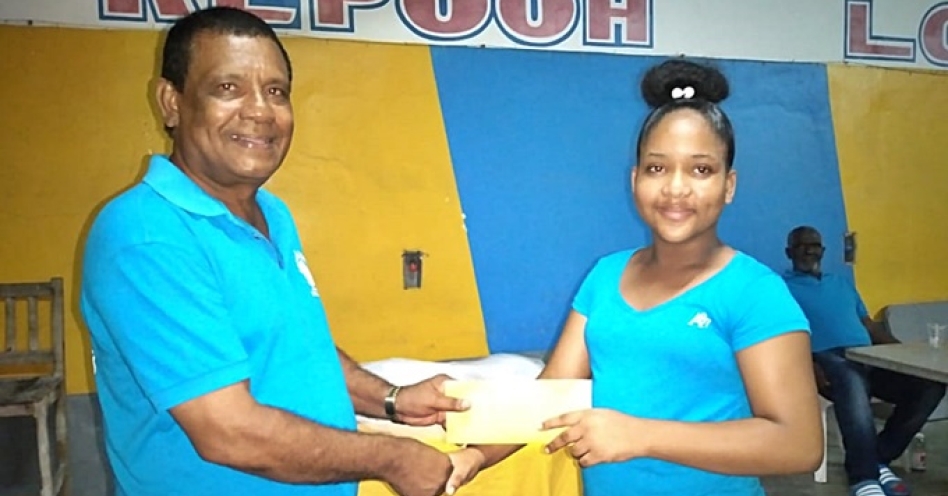 Justin Hooper (left), club president, Repooh Domino & Social Club makes a presentation to Judi Dookie