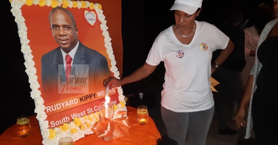 Dahlia Mears, wife of Rudyard 'Kippy' Mears lights a candle at a vigil in honour of her husband. (OH News Photo)