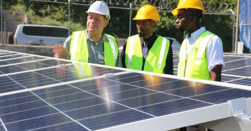 Audley Shaw, Minister of Industry, Commerce, Agriculture and Fisheries examines the solar panels at the NIC Bengal Pump Station in Trelawny