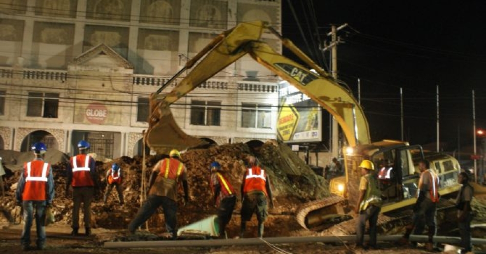 National Water Commission (NWC) workmen carry out pipe-laying works along Constant Spring Road in St. Andrew.