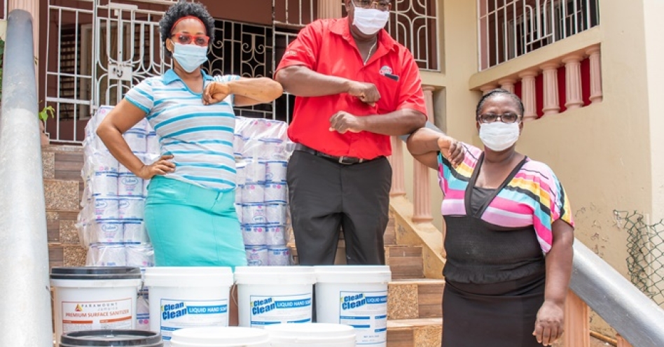 (l-r) Teres Bradford, Residential House Mother at the Yadel Girls Home in Old Harbour, St Catherine; Human Resource Manager at RUBiS, Donnovan Dobson and Housekeeper, Janet Bennett acknowledge RUBiS’ donation of personal protective equipment (PPE) items with a suitable elbow gesture, following the presentation of personal care items, surface cleaners, masks, and hand sanitizers on July 2.