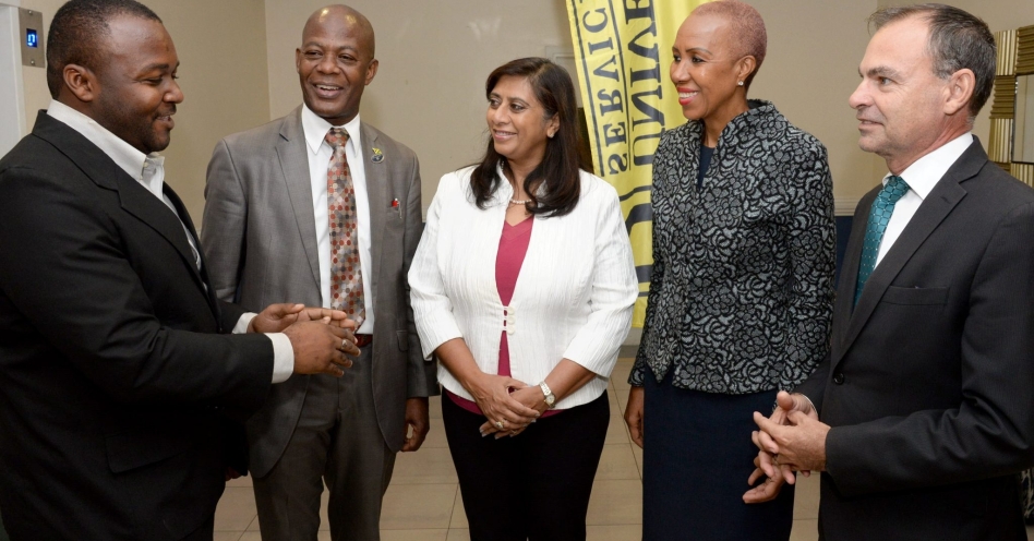 Participant in the Technology Advancement Programme (TAP),Oshane Stewart (left), speaking to (from left):Chief Executive Officer, Universal Service Fund (USF), Daniel Dawes; Chairman, USF, Dr. Gunjan Ramsingh; Minister of Science, Energy and Technology, Hon. Fayval Williams, and National Coordinator, Housing, Opportunity, Production and Employment (HOPE) Programme, Lieutenant Colonel Martin Rickman, during the launch of the second phase of TAP, at The Jamaica Pegasus hotel, on Tuesday (July 30).