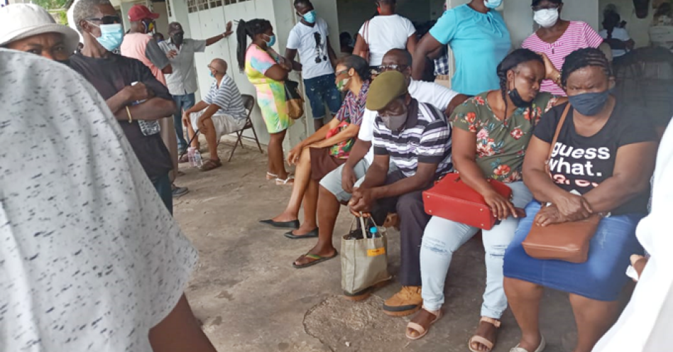 Persons waiting to be vaccinated at the Lions Club Civic Centre, Old Harbour today. (OH News Photo)