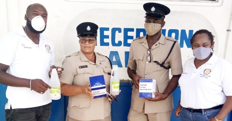 Anne-Marie Bishop (right) and Cardel Caszely (left) of the Rotary Club of Ocho Rios donate masks and hand sanitizers to the St Catherine North Police Division.