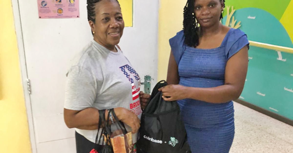 Pollyanna Project volunteer Sheryl Falchnor (left) makes a presentation to one of the mothers.
